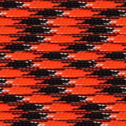 A close-up of a woven fabric featuring a repetitive geometric pattern with interlocking shapes in black and orange, accented by small white dots. The texture appears tightly knit and reminiscent of high strength cord like "Orange You Happy" 550 Paracord - High-Strength & Versatile Made in USA by Insanely Paracord, giving it a detailed and intricate appearance perfect for emergency and survival situations.