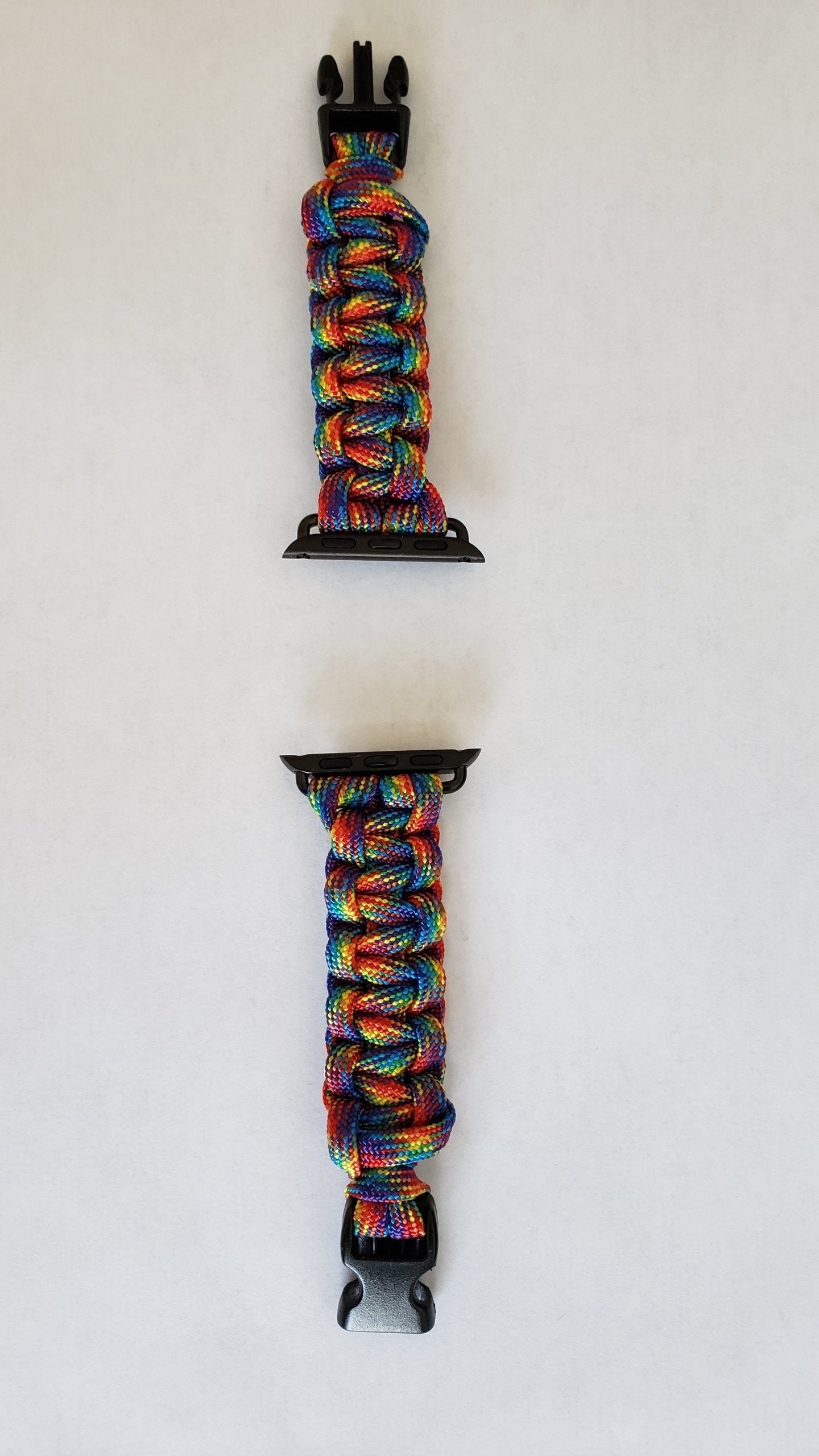 a pair of colorful bracelets hanging on a wall