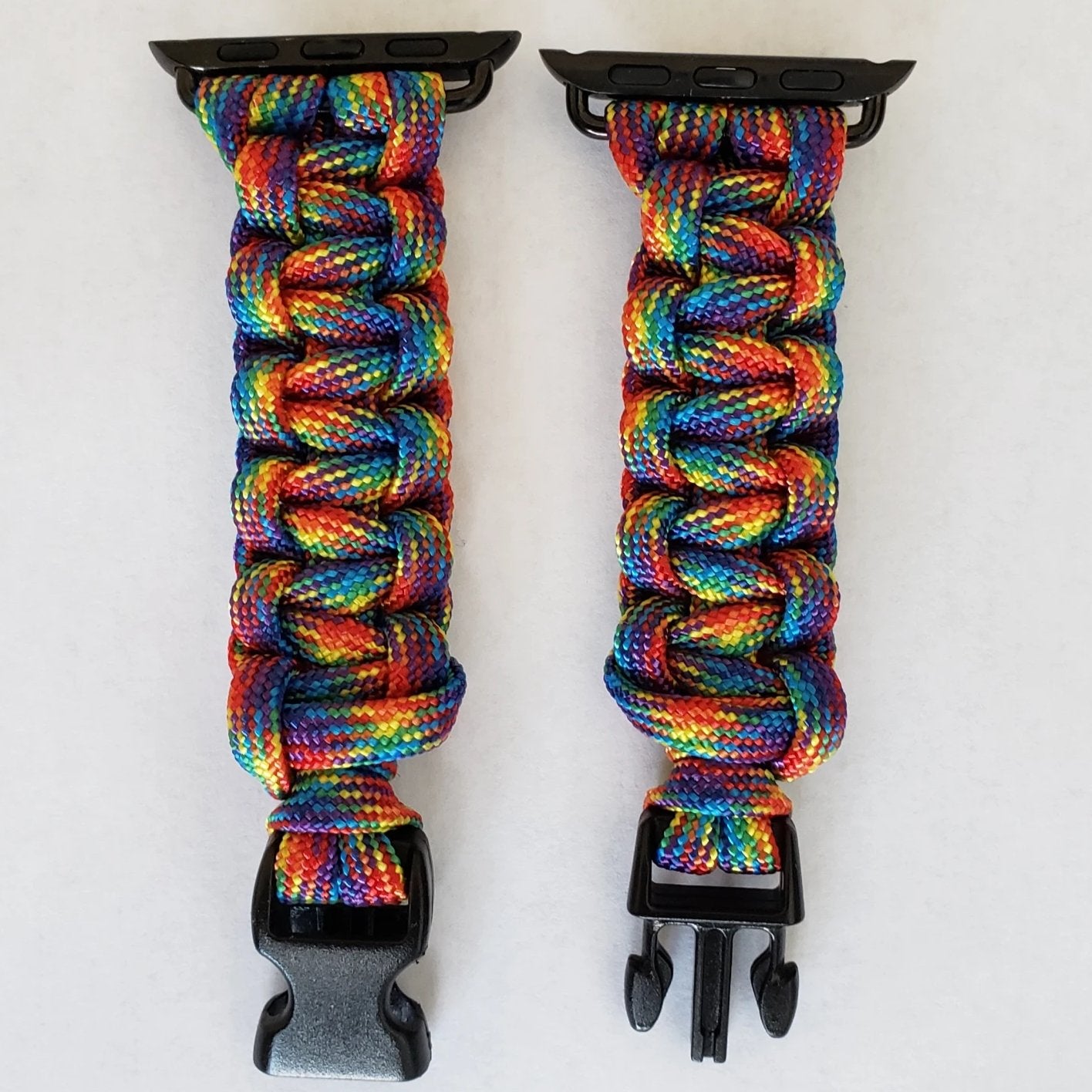 a pair of black clips holding a multicolored paracorage
