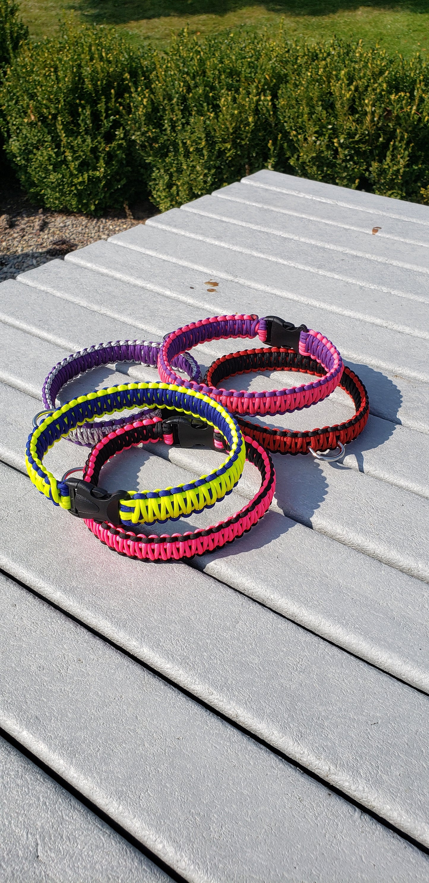 a set of collars sitting on top of a wooden table