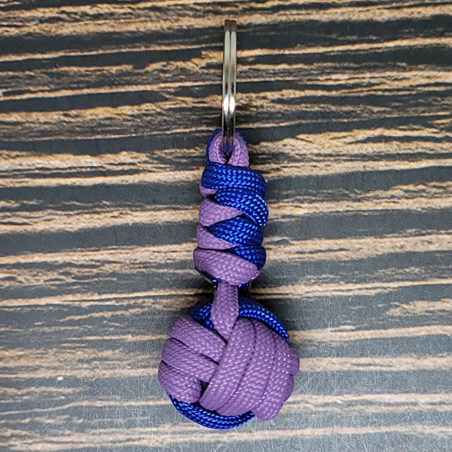 a purple and blue knot hanging from a hook