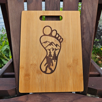 a wooden cutting board with a picture of a foot on it