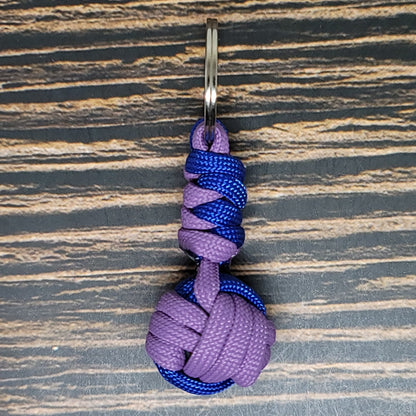 a purple and blue knot hanging from a hook