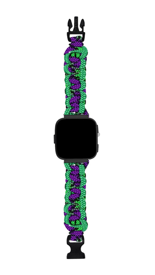 A TeeInBlue Fitbit Paracord Watch Band - Durable, Stylish, and Made in USA with a black face and a band woven from durable green, purple, and black paracord. The band features a plastic buckle clasp. The watch face is blank, and the woven pattern of the paracord watch band provides a textured, colorful design compatible with multiple smartwatch brands.