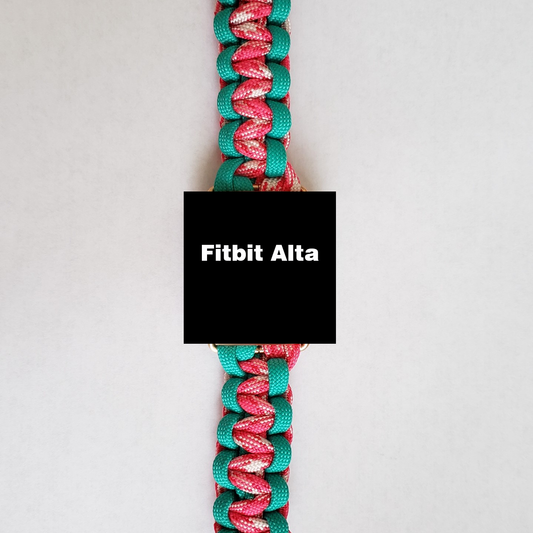 A close-up image of an Insanely Paracord Fitbit Alta Watch Band - Paracord, High-Quality, USA Made with a colorful, durable watch band. The band is braided with teal, pink, and white strands, displayed vertically. The black screen of the device reads "Fitbit Alta.