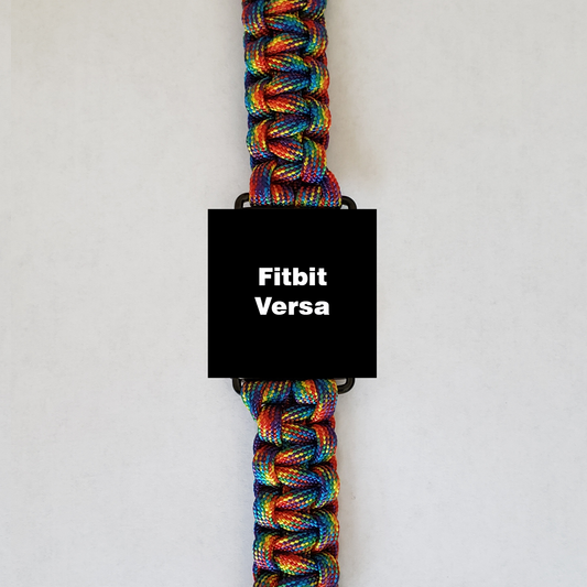 An Insanely Paracord Fitbit Versa Paracord Watch Band - Durable, Stylish, & Customizable with a vibrant, high-quality paracord band made of multicolored strands. The rainbow spectrum of the paracord watch bands stands out, while the watch face displays "Fitbit Versa" on a black background. Perfect for outdoor activities, it is set against a plain white backdrop.