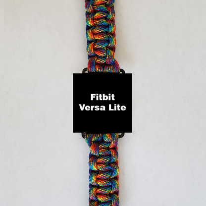 An Insanely Paracord Fitbit Versa Lite Paracord Watch Bands - Durable, Stylish, and Customizable smartwatch with a screen displaying the text "Fitbit Versa Lite" is shown. It features a high-quality paracord watch band in a woven pattern, predominantly showcasing red, blue, green, and yellow hues. The background is plain white.