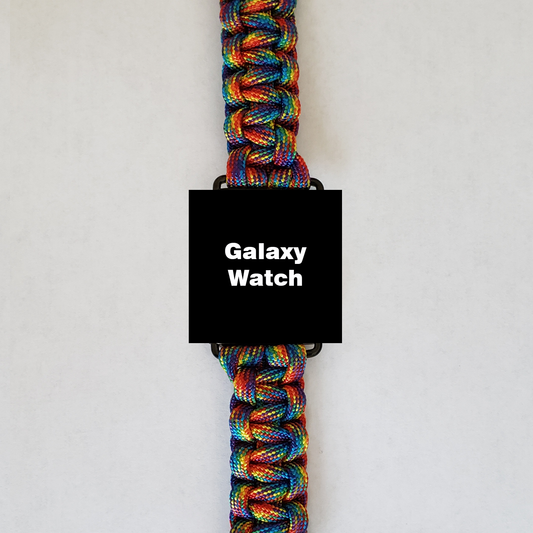 A smart watch with the text "Galaxy Watch" on its screen is shown against a plain background. The intricately woven watch band is an Insanely Paracord Galaxy Watch 42mm Paracord Watch Band - High-Quality, Durable, & Stylish, featuring vibrant, multicolored strands that catch the eye.