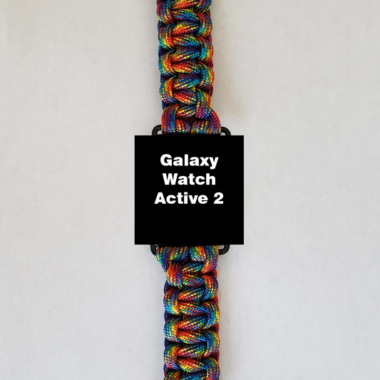 An Insanely Paracord Galaxy Watch Active 2 with a vibrant rainbow-colored paracord watch band - durable, stylish, & versatile, perfect for outdoor enthusiasts, is displayed against a plain white background. The watch face is black and features the text "Galaxy Watch Active 2" in white.