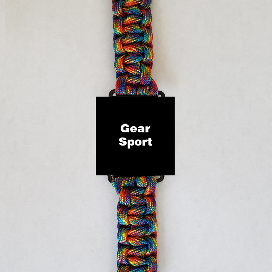 A high-quality Insanely Paracord Gear Sport Paracord Watch Band - High-Quality, Durable, and Stylish Smartwatch Accessory with a black rectangular element in the middle displaying "Gear Sport" in white. The tightly woven paracord features vibrant hues of blue, green, yellow, red, and orange, making it perfect for outdoor enthusiasts. The background is plain white.
